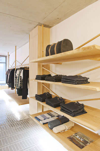 Oak shelves, hanging rails and display units with integrated lighting